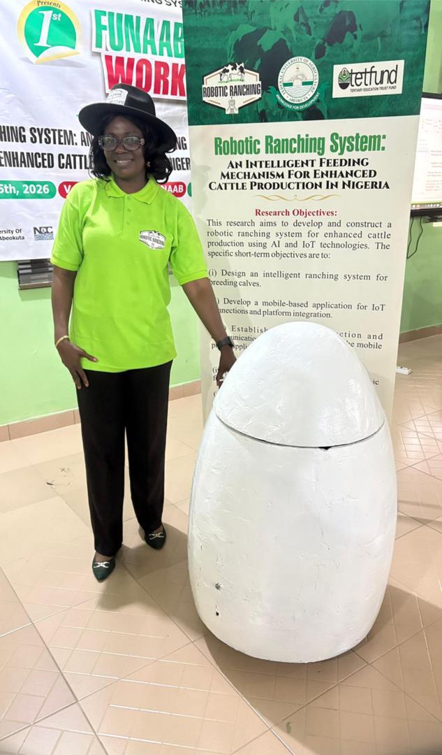 A team member with the prototype and the research poster.