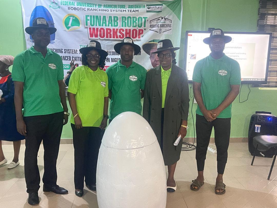Members of the research team with the prototype at the 1st FUNAAB Robot Workshop.
